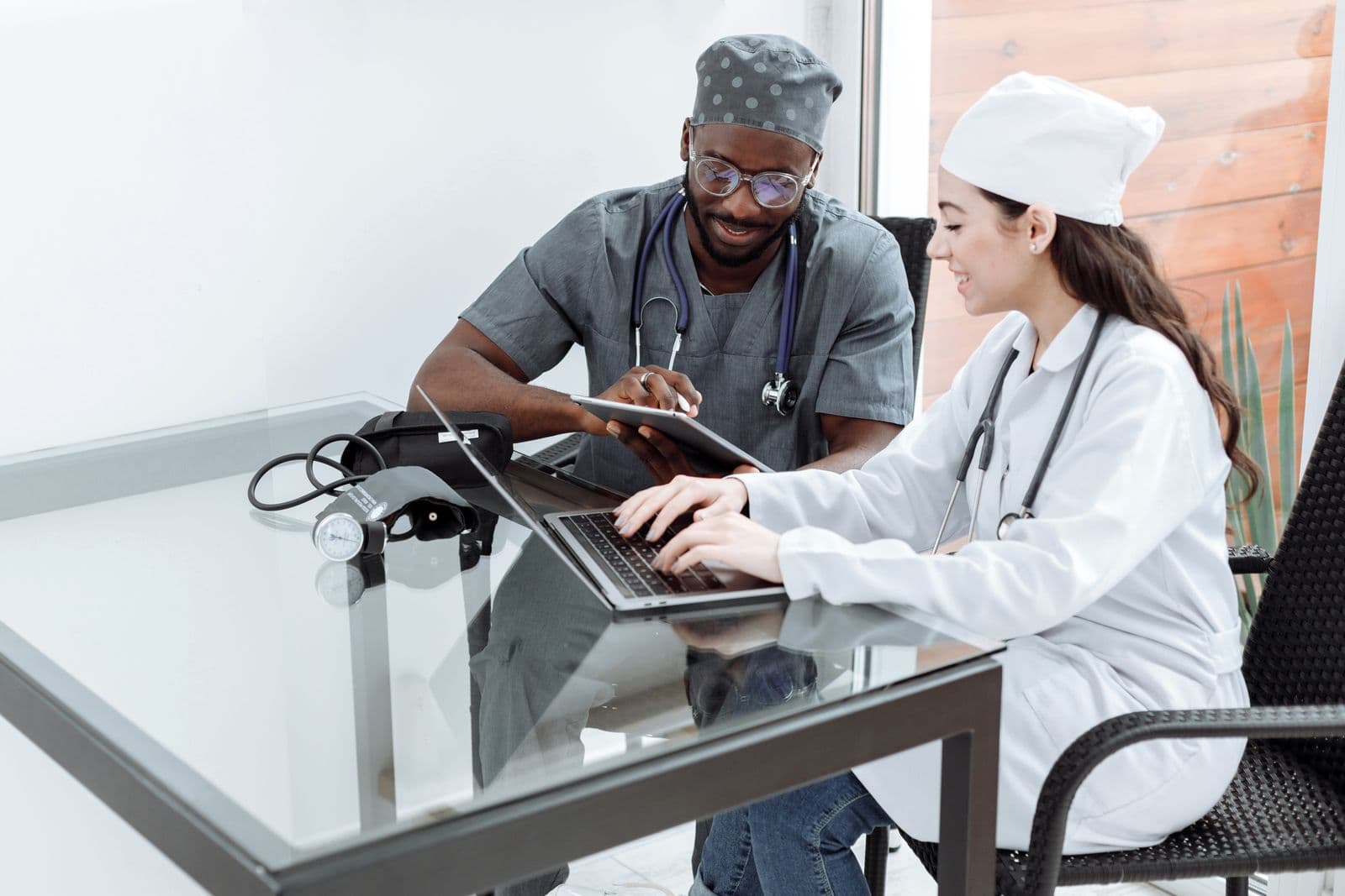 Two clinicians working on their devices side by side